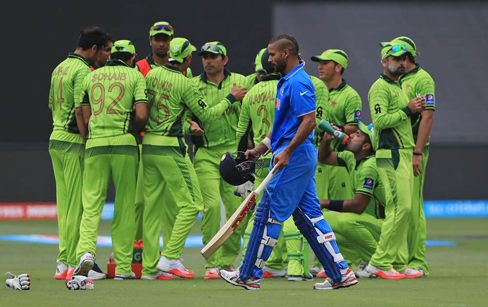 Shikhar Dhawan, walks back after he was run out during the World Cup Pool B match against Pakistan in Adelaide, Australia.