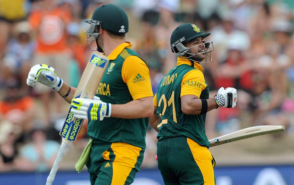 South Africa's Jean-Paul Duminy, celebrates along with teammate David Miller after Duminy made 100 runs against Zimbabwe during their Cricket World Cup pool B match at Hamilton, New Zealand.