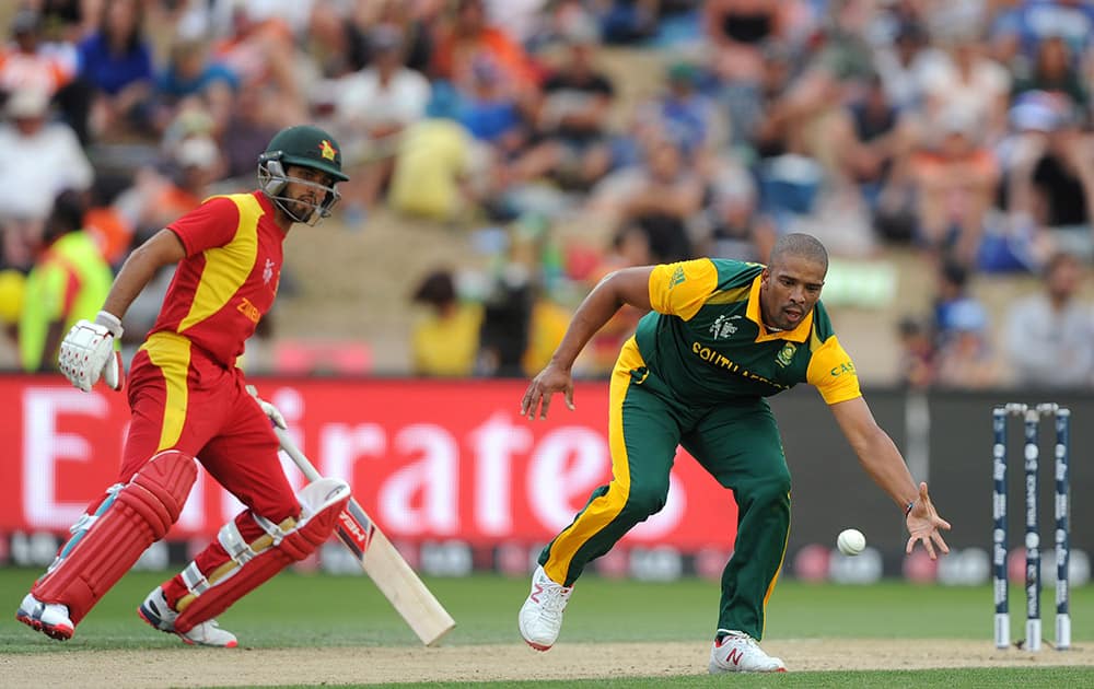 South Africa's Vernon Philander, fields the ball in front of Zimbabwe's Sikandar Raza during their Cricket World Cup pool B match at Hamilton, New Zealand.