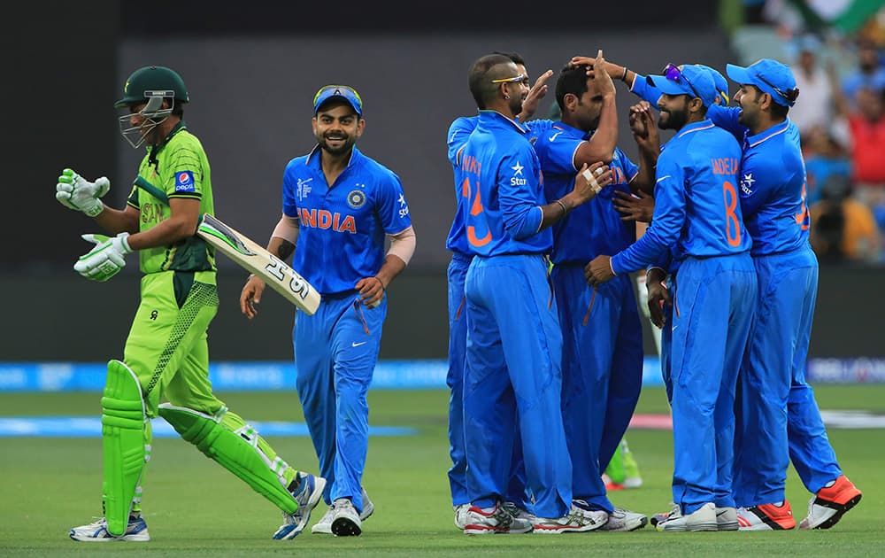 Younis Khan, walks back as Indian players celebrate his dismissal during the World Cup Pool B match in Adelaide, Australia.