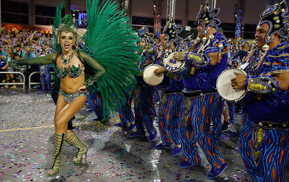A dancer from the Vila Maria samba school performs during a carnival parade in Sao Paulo, Brazil.