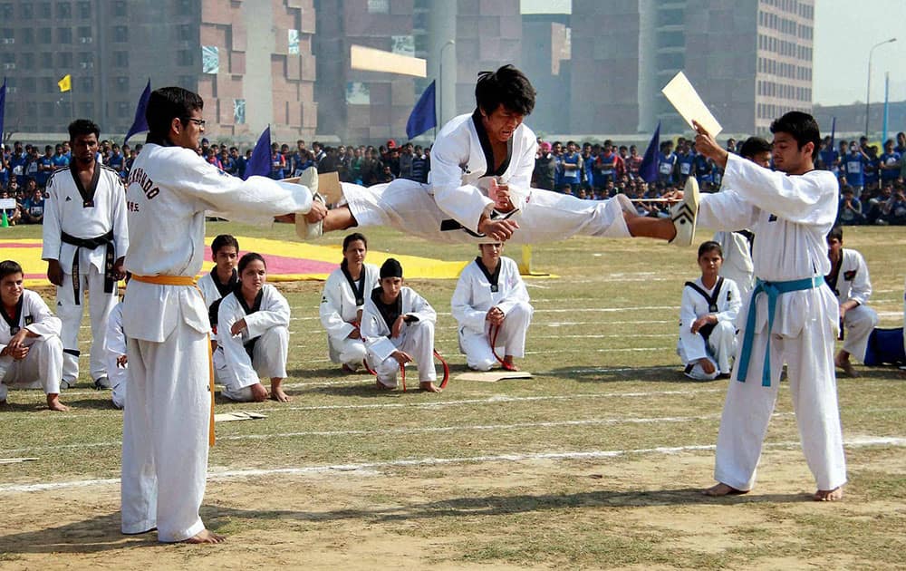 Students perform a Karate stunt during 7th Annual Sports Meet in Jalandhar.