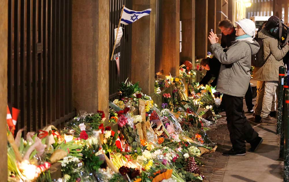 Flowers are placed in front of the synagogue where one person was killed in Copenhagen, Denmark.