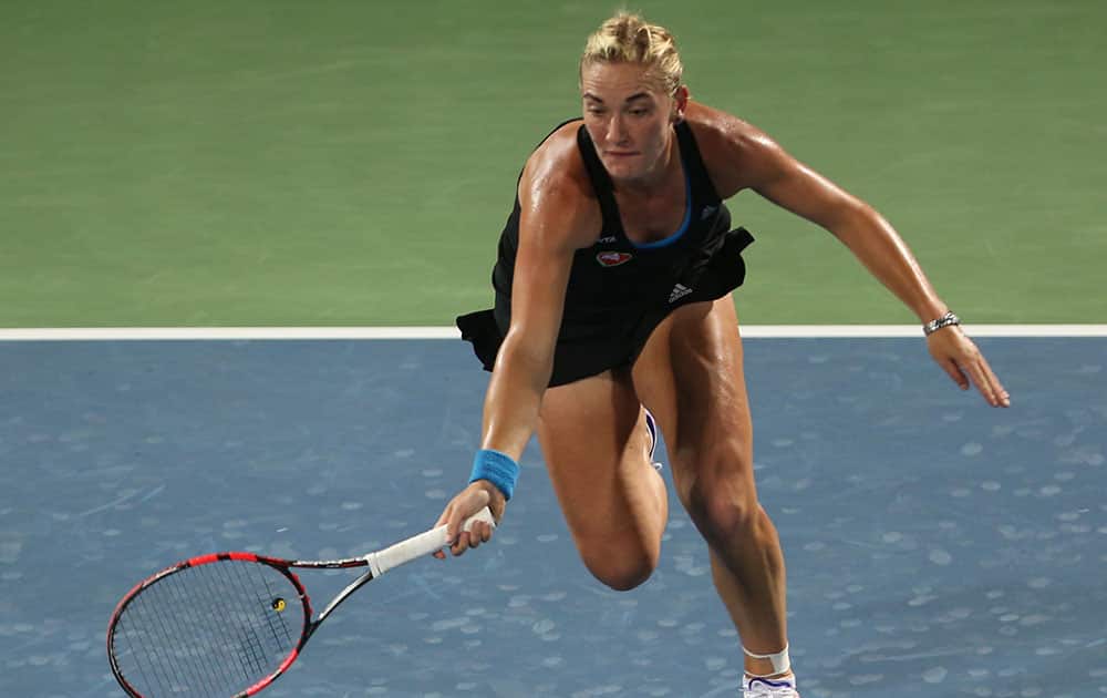 Timea Babos of Hungry returns the ball to Jelena Jankovic of Serbia during the first day of Dubai Duty Free Tennis Championships in Dubai, United Arab Emirates.