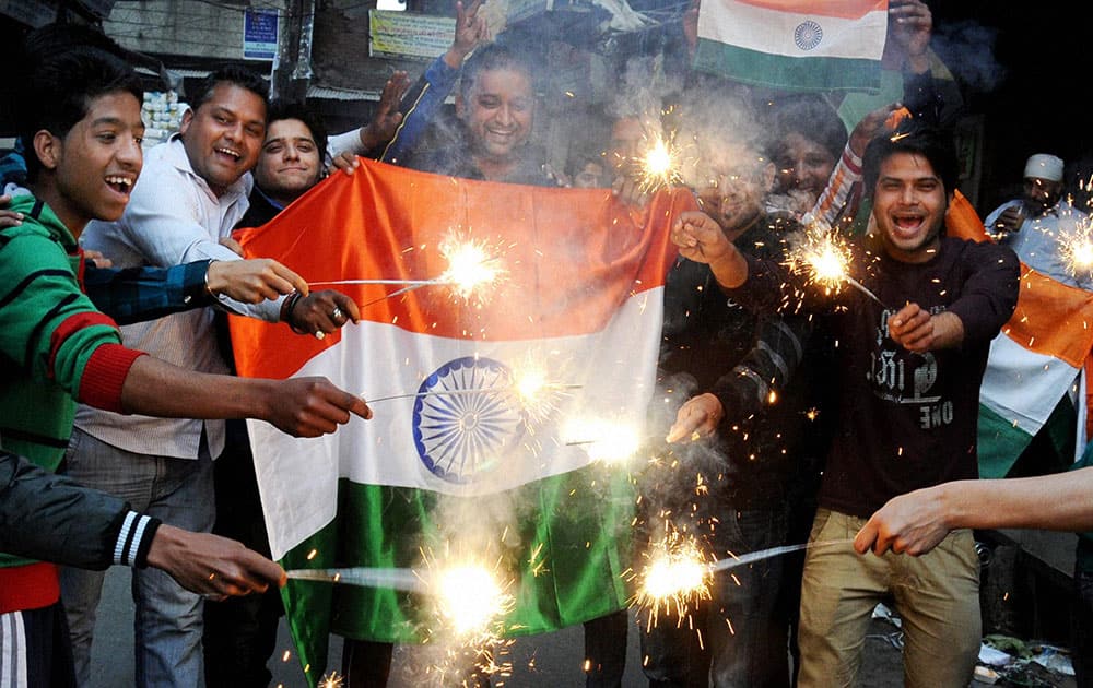 Cricket fans celebrate after team India's victory in the ICC World Cup Pool B match against Pakistan, in Amritsar.