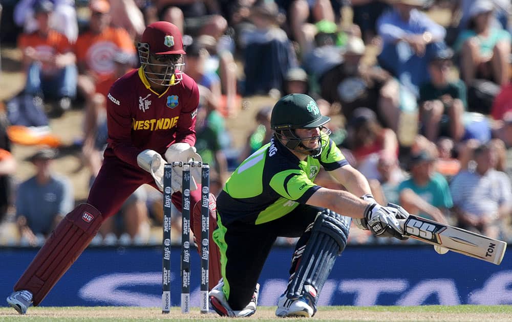 Ireland's Paul Stirling, right, sweeps the ball in front of West Indies's Denesh Ramdin during their Cricket World Cup pool B match at Nelson, New Zealand.