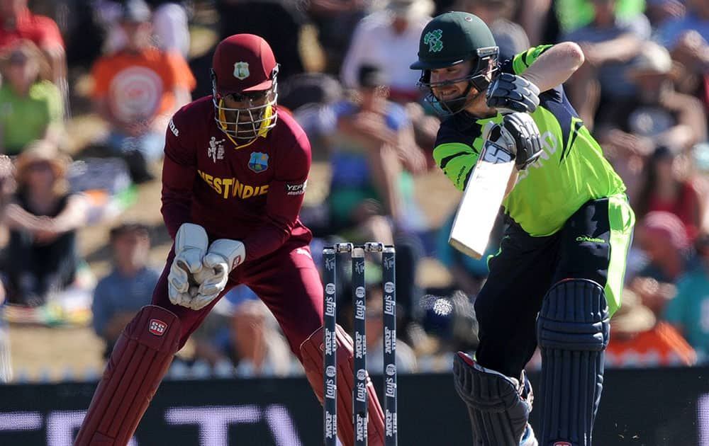 West Indies's Denesh Ramdin, left, catches the ball edged by Ireland's Paul Stirling, right, during their Cricket World Cup pool B match at Nelson, New Zealand.