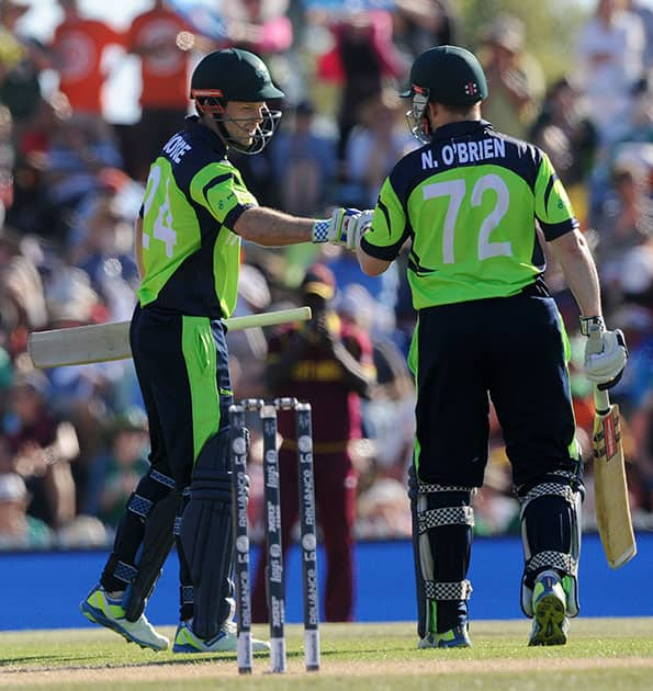 Ireland's Ed Joyce, left, and Niall O'Brien meet mid-pitch during their Cricket World Cup pool B match against West Indies at Nelson, New Zealand.