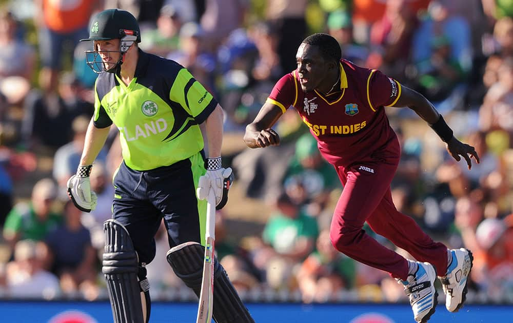 West Indies' Jerome Taylor, right, flies as he delivers a ball watched by Ireland's Niall O'Brien during their Cricket World Cup pool B match at Nelson, New Zealand.