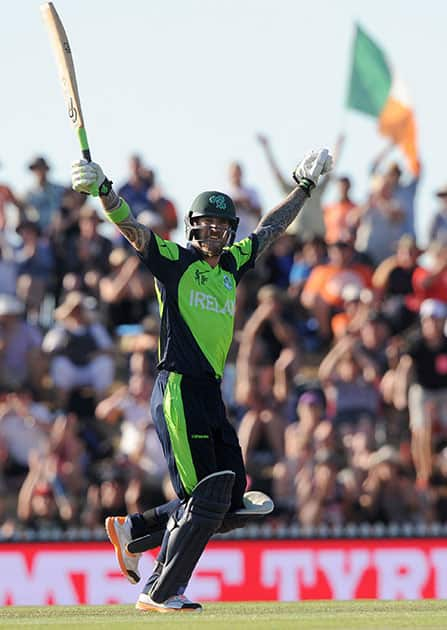 Ireland's John Mooney raises his arms after hitting the winning runs against West Indies during their Cricket World Cup pool B match at Nelson, New Zealand.