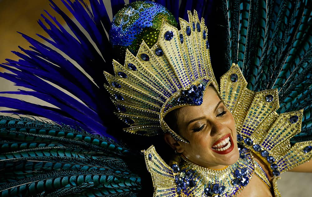 A performer from the Academicos do Grande Rio samba school parades during carnival celebrations at the Sambadrome in Rio de Janeiro, Brazil.