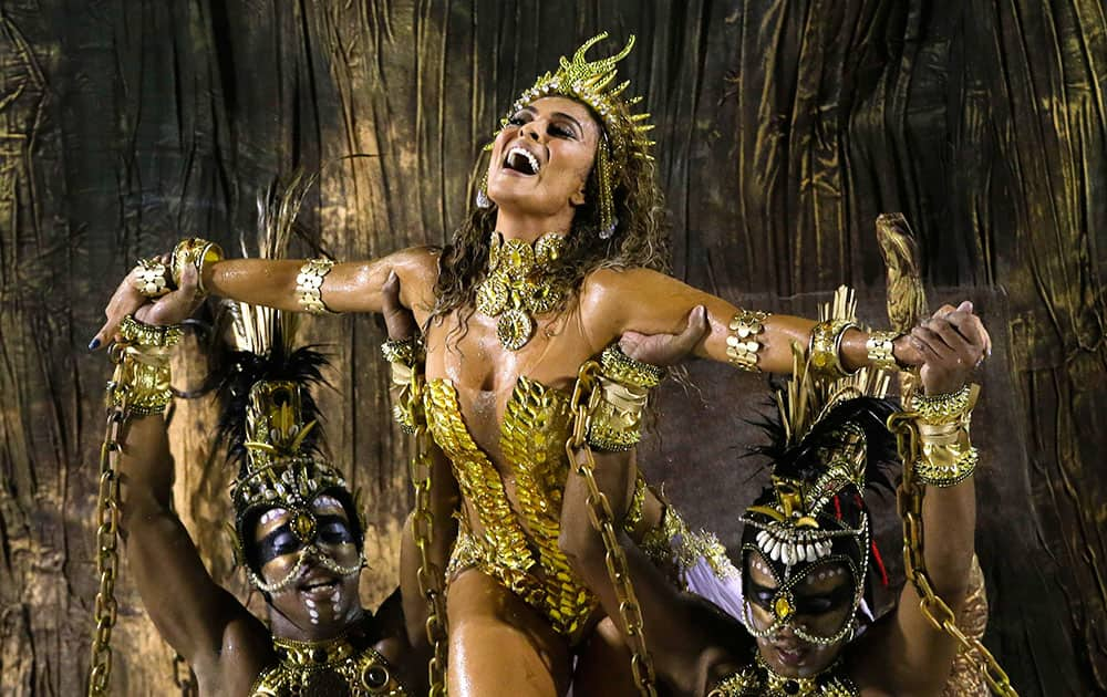 Actress Juliana Paes is carried by dancers of the Viradouro samba school in the Carnival parade at the Sambadrome in Rio de Janeiro, Brazil.