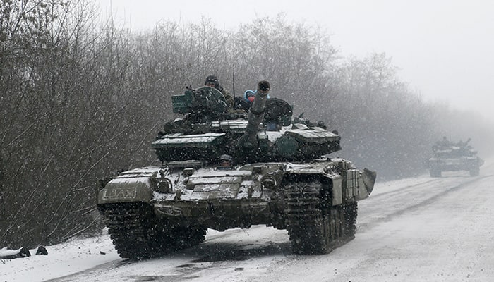 An Ukrainian armored vehicles drive on the road between the towns of Debaltseve and Artemivsk, Ukraine.