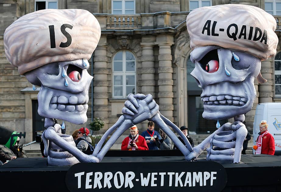 A carnival float depicts a writing 'terror competition' underneath skeletons with turbans and the writings IS and Al-Qaida during the traditional Rose Monday carnival parade in Duesseldorf, Germany.