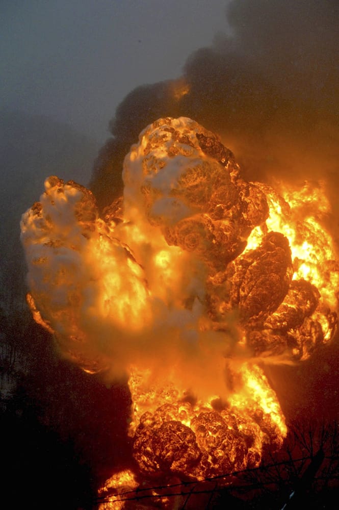 A fire burns, after a train derailment near Charleston, W.Va. Nearby residents were told to evacuate as state emergency response and environmental officials headed to the scene. 