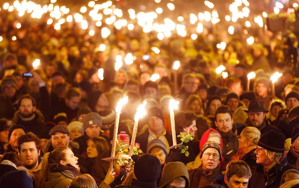 Hundreds of people gather for a vigil near the cultural club in Copenhagen, Denmark.