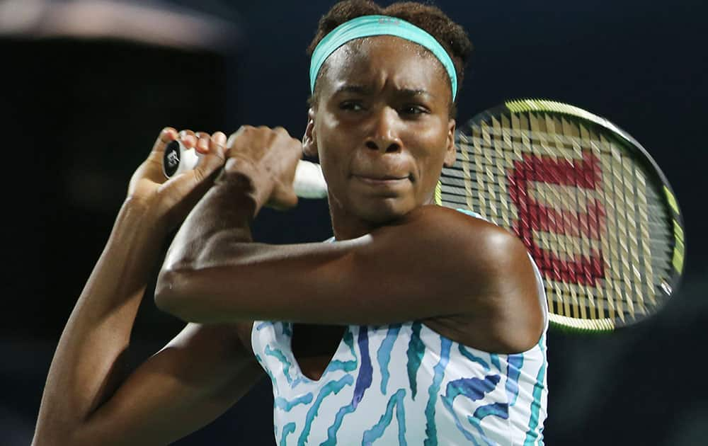 Venus Williams of the U. S. returns the ball to Belinda Bencic of Switzerland during the second day of Dubai Duty Free Tennis Championships.