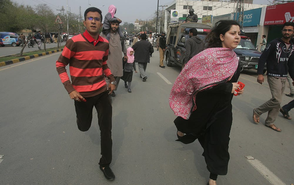 People run following a bombing in Lahore, Pakistan.