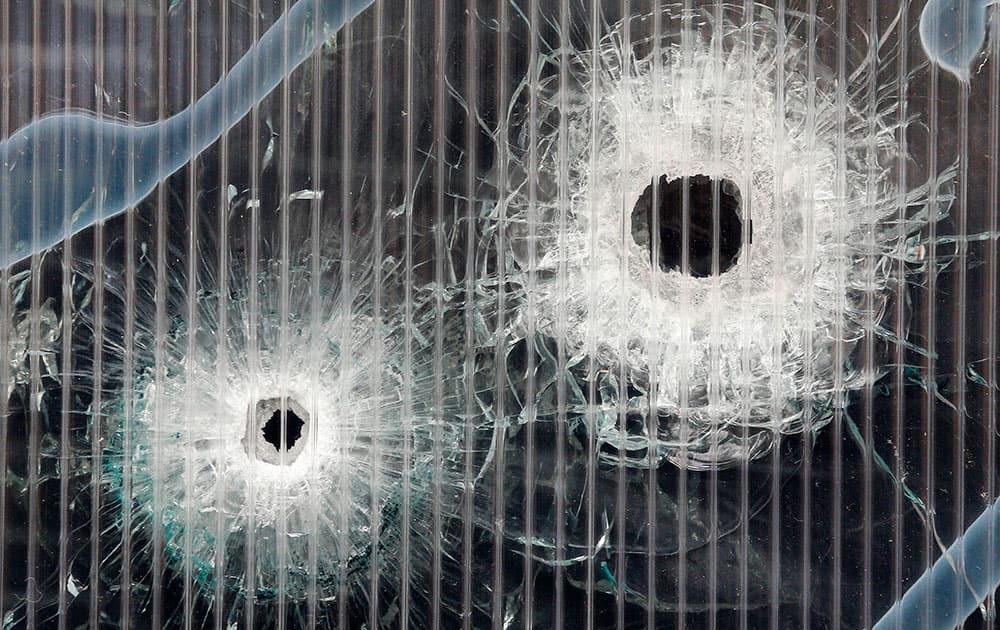 Bullet holes are seen in a window of a cultural club after an shooting attack in Copenhagen, Denmark.