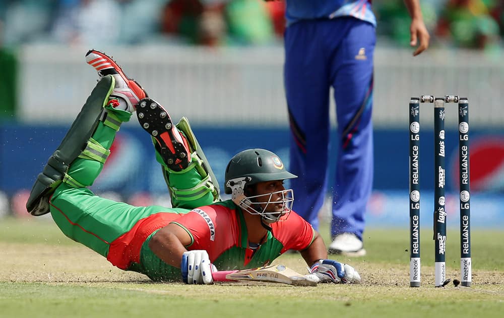 Bangladesh batsman Iqbal Tamim dives to make his ground during their Cricket World Cup Pool A match against Afghanistan in Canberra, Australia.