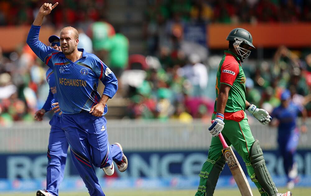 Bangladesh batsman Iqbal Tamim walks from the field after he was dismissed for 19 runs as Afghanistan bowler Ashraf Merwais celebrates during their Cricket World Cup Pool A match in Canberra, Australia.