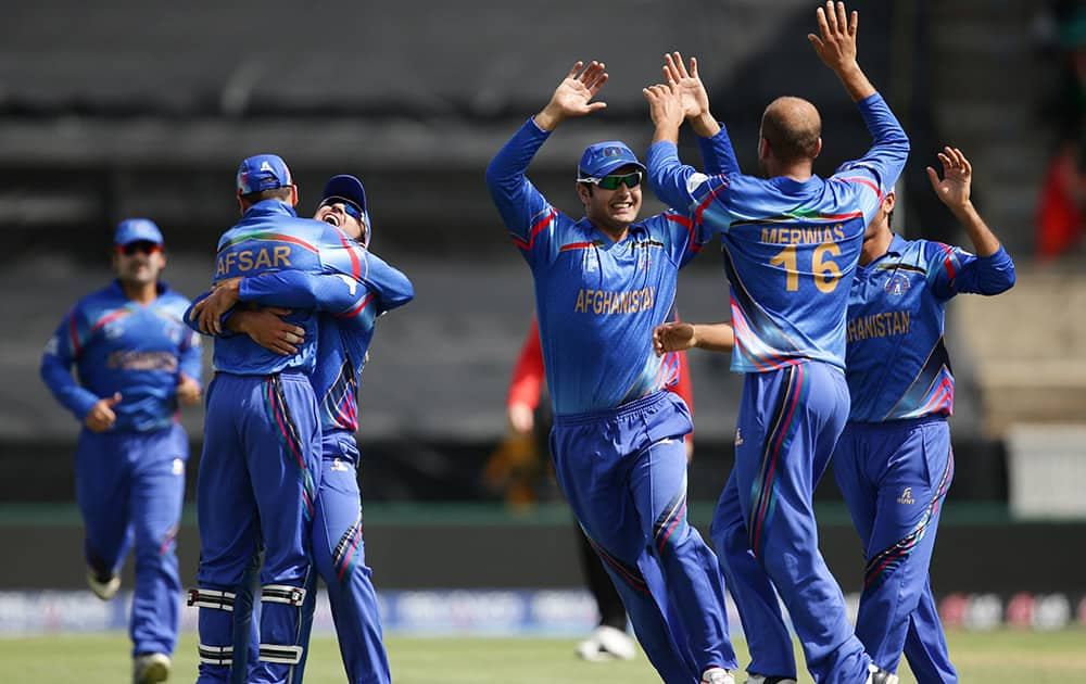 Afghanistan player's celebrate after taking the wicket of Bangladesh batsman Iqbal Tamim during their Cricket World Cup Pool A match in Canberra, Australia.