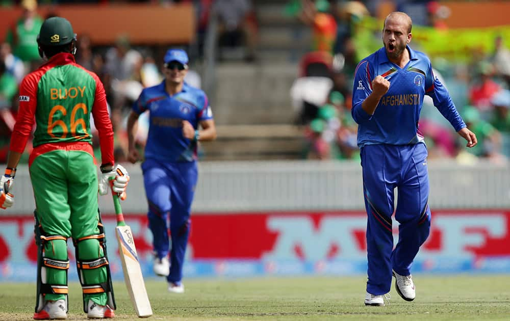 Afghanistan bowler Ashraf Merwais celebrates after dismissing Bangladesh’s Haque Anamul for 29 runs during their Cricket World Cup Pool A match in Canberra, Australia.