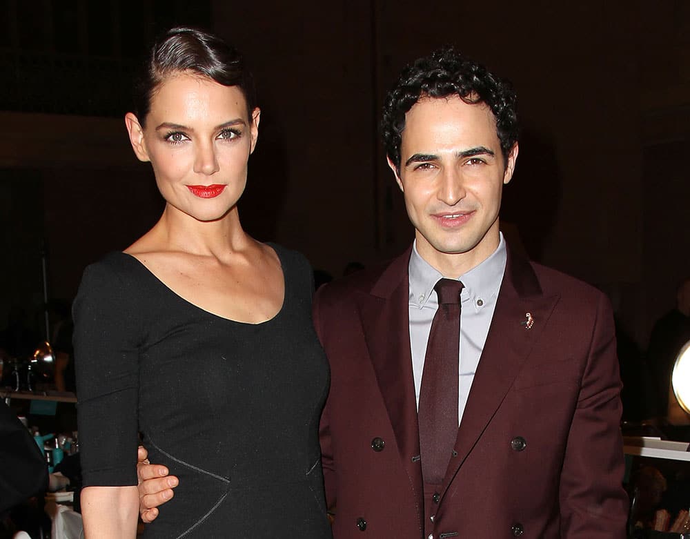 Katie Holmes, left, poses with Zac Posen at Posen's Fall 2015 show during Fashion Week in New York