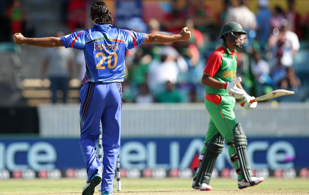 Afghanistan’s Zadran Shapoor celebrates after dismissing Bangladesh batsman Mahmudullah, during their Cricket World Cup Pool A match in Canberra, Australia.