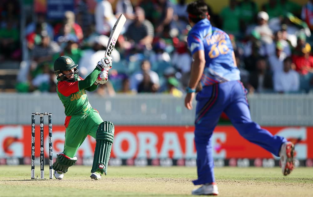 Bangladesh batsman Rahim Mushfiqur hits the ball for four runs as Afghanistan bowler Hassan Hamid looks on during their Cricket World Cup Pool A match in Canberra, Australia.