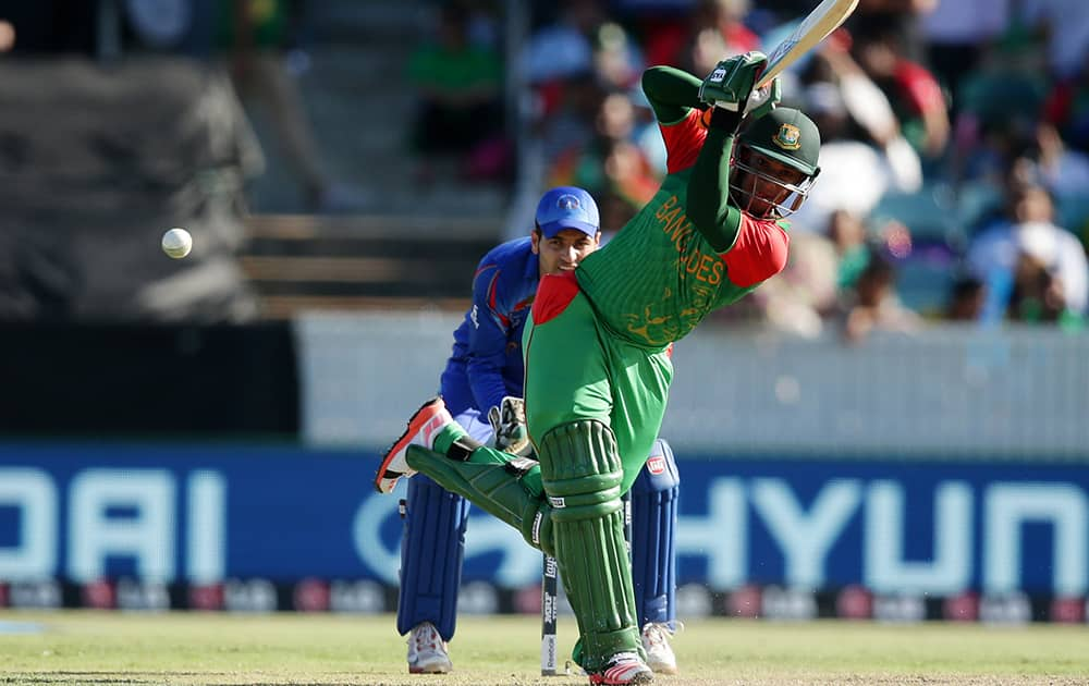 Bangladesh batsman Al Hasan Shakib watches his shot as Afghanistan’s wicketkeeper Zazai Afsar looks on during their Cricket World Cup Pool A match in Canberra, Australia.