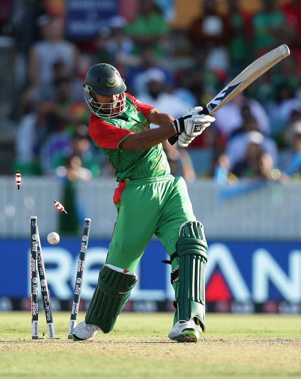 Bangladesh’s Bin Mortaza Masrafe is bowled during their Cricket World Cup Pool A match against Afghanistan in Canberra, Australia.