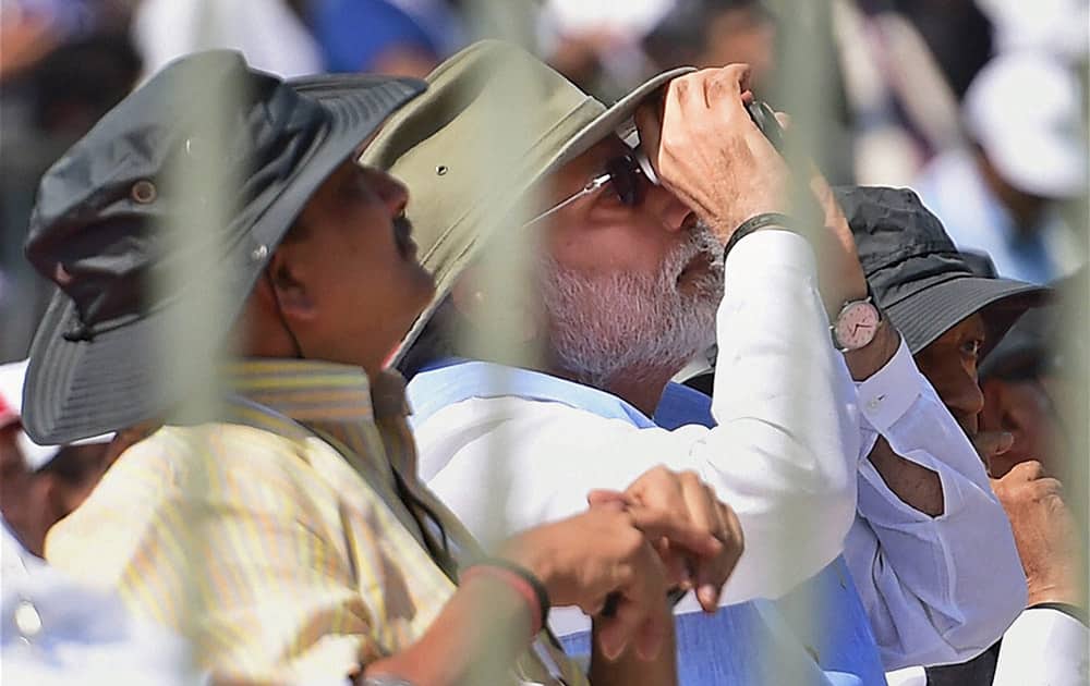 Prime Minister Narendra Modi and Defence Minister Manohar Parrikar watching the flying past display during the inauguration of the Aero India 2015, Asias Premier Air Show at Yelhanka Air Base in Bengaluru.