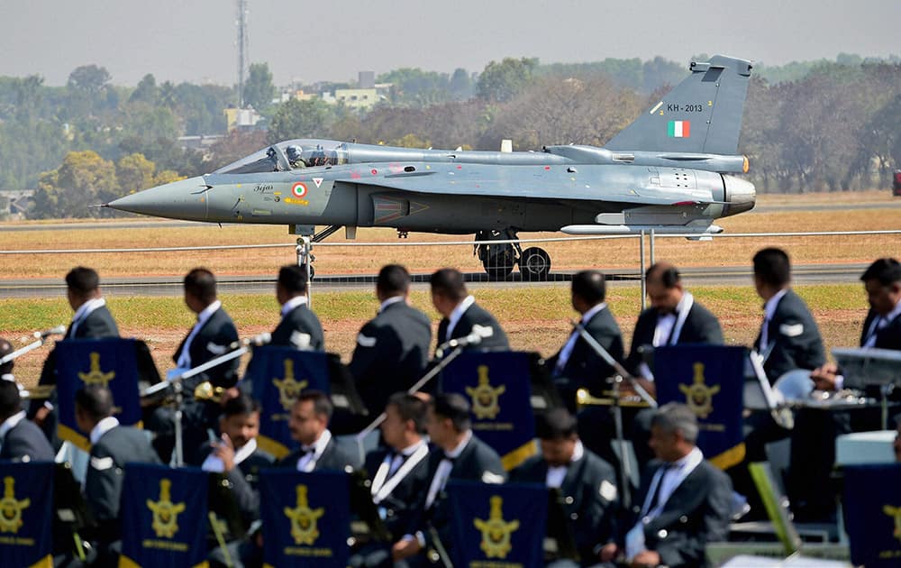 Light Combat Aircraft Tejas prepares to fly during the inauguration of the Aero India 2015 event at Yelhanka Air Base in Bengaluru.