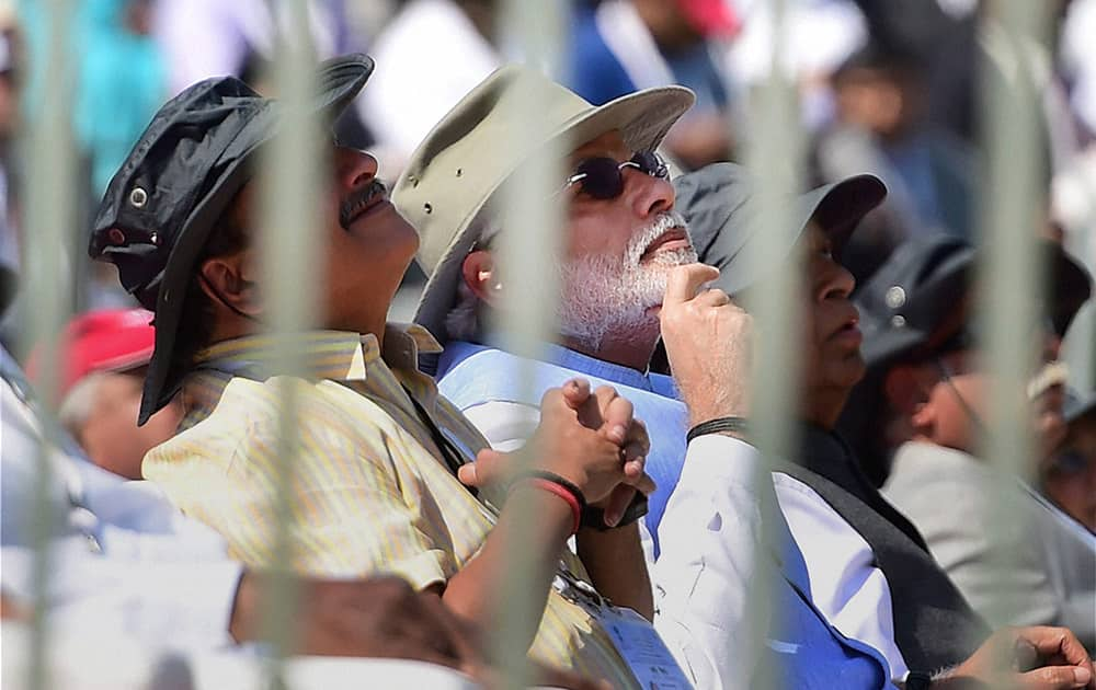 Prime Minister Narendra Modi and Defence Minister Manohar Parrikar watching the flying past display during the inauguration of the Aero India 2015, Asias Premier Air Show at Yelhanka Air Base in Bengaluru.