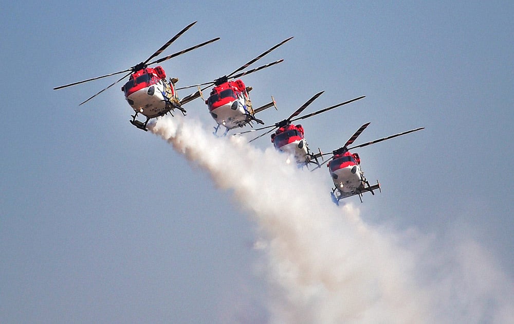 The Indian Air Forces' helicopter display teams' 'Sarang' performs during the inauguration of the Aero India 2015 event at Yelhanka Air Base in Bengaluru.