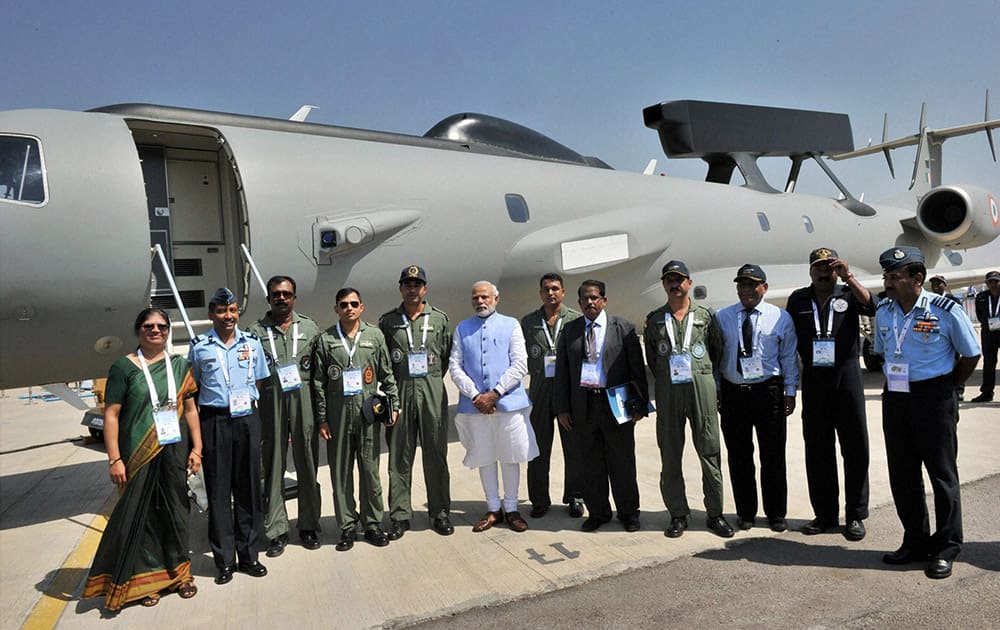 Prime Minister Narendra Modi poses for a group photograph during the inauguration of the Aero India 2015 event at Yelhanka Air Base in Bengaluru.