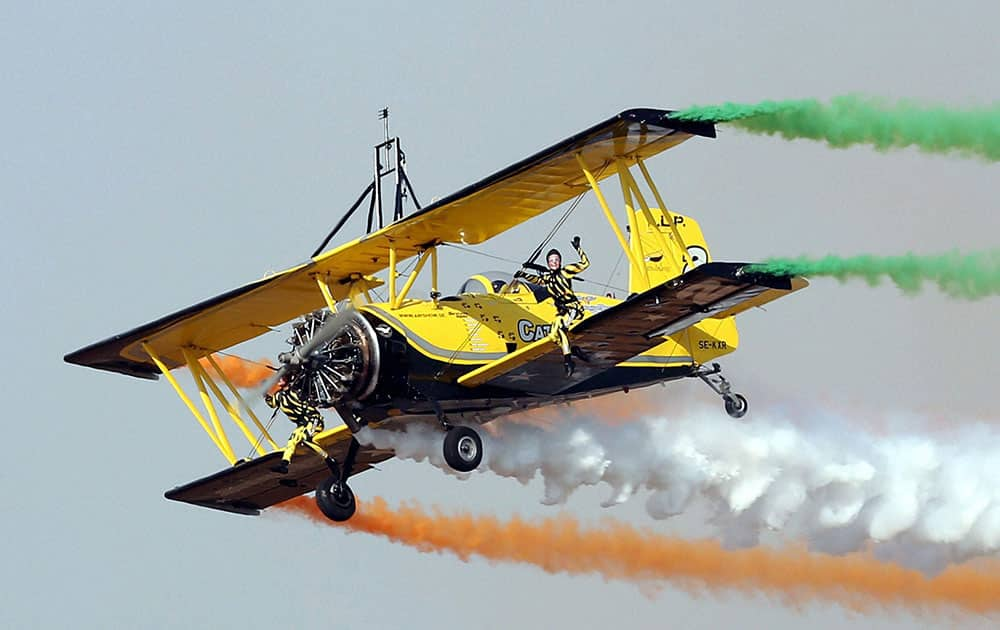 Swedens aerobatic display team Scandinavian Air Show performs during the inauguration of the AERO INDIA 2015 at Yelahanka Air Base in Bengaluru.