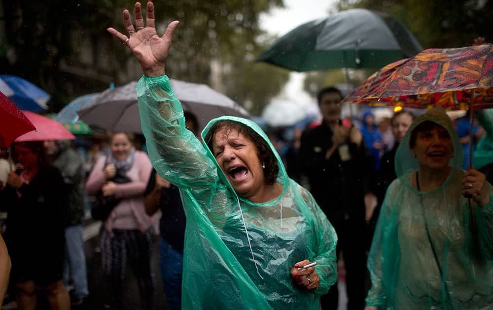 A protester chants anti-government slogans during a march demanding answers from the government in the mysterious death of prosecutor Alberto Nisman one month ago in Buenos Aires, Argentina.