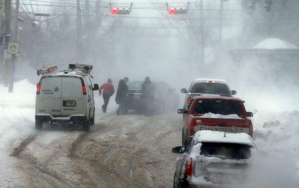 Good Samaritans helped push a car up South Upper St. during a heavy morning snow in Lexington, Ky.