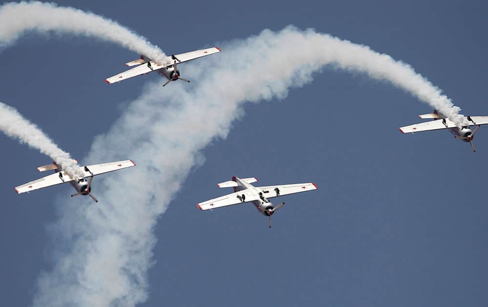 Russian aerobatic team Yakovlev fly upside down on the second day of Aero India 2015 at Yelahanka air base in Bangalore, India.