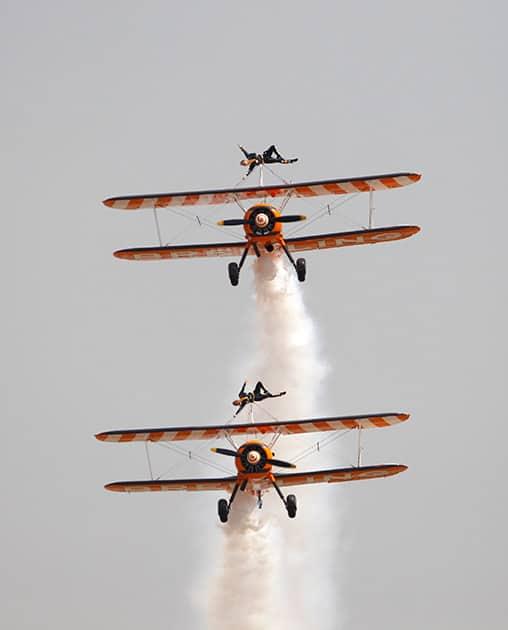 Members of British aerobatics team Breitling Wingwalkers perform on the second day of Aero India 2015 at Yelahanka air base in Bangalore