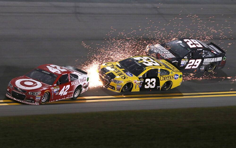 Kyle Larson (42) spins in front of Ty Dillon (33) and Justin Marks (29) during the first of two qualifying races for the Daytona 500 NASCAR Sprint Cup series auto race at Daytona International Speedway in Daytona Beach, Fla.
