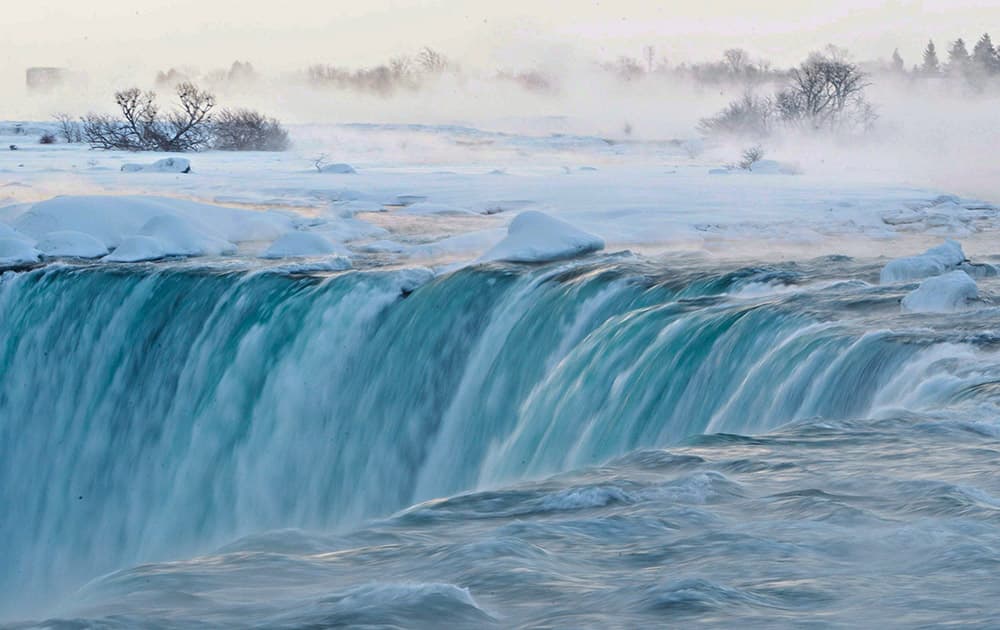 Pieces of ice flow over the Canadian 'Horseshoe' Falls in Niagara Falls, Ontario, Canada.