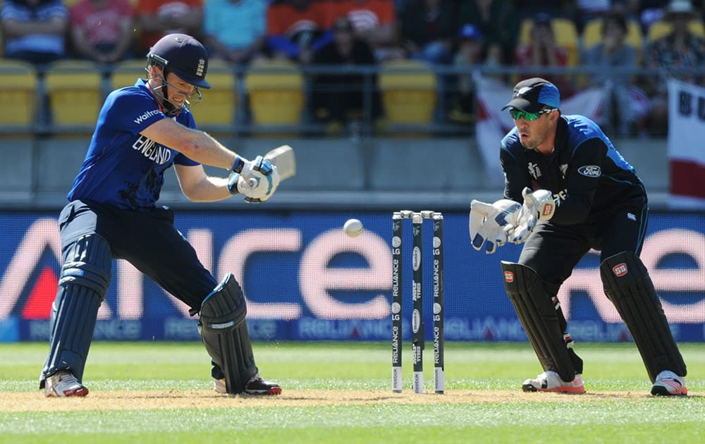 England’s captain Eoin Morgan looks to play a shot as New Zealand wicketkeeper Luke Ronchi looks on during their Cricket World Cup match in Wellington, New Zealand.