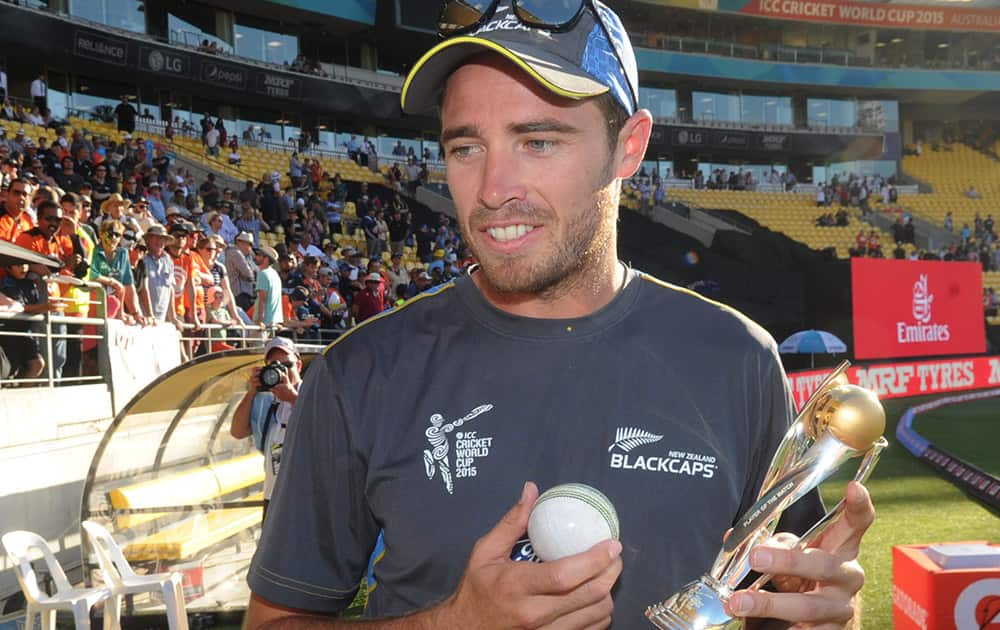 New Zealand bowler Tim Southee holds his man of the match trophy after taking seven wickets in New Zealand's eight wicket win over England in their Cricket World Cup match in Wellington, New Zealand.