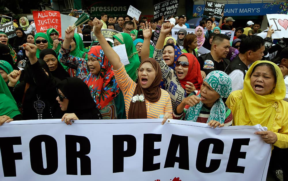 People chant during a rally near the Presidential Palace to call for the passage of Bangsamoro Basic Law or BBL in the southern Philippines.
