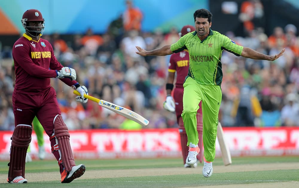 Pakistan bowler Sohail Khan, right, celebrates after taking the wicket of West Indies batsman Dwayne Smith, left, during their Cricket World Cup match in Christchurch, New Zealand.