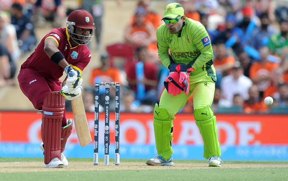 West Indies batsman Darren Bravo plays a shot as Pakistan wicketkeeper Umar Akmal looks on during their Cricket World Cup match in Christchurch, New Zealand.