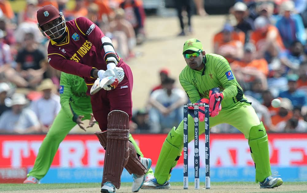 West Indies batsman Marlon Samuels plays a shot as Pakistan wicketkeeper Umar Akmal looks on during their Cricket World Cup match in Christchurch, New Zealand.